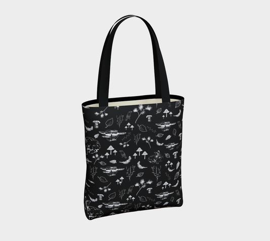 Tote bag with nature themed print in white on a black background.