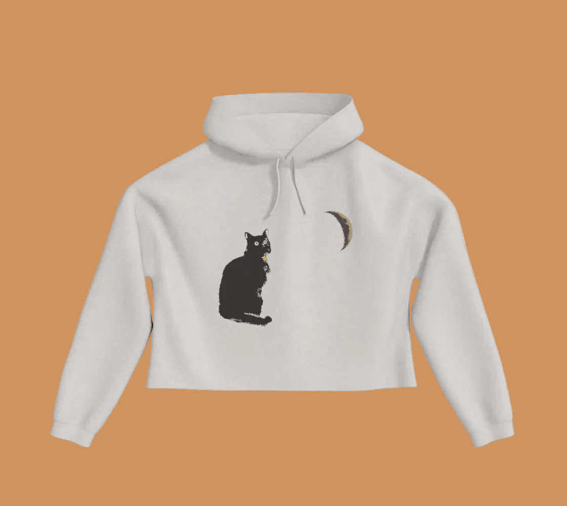 Bone coloured cropped hoodie with a cat and crescent moon on the front.